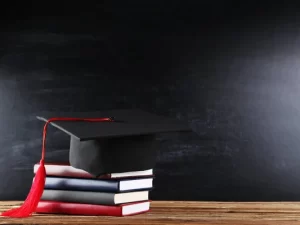 depositphotos_255028716-stock-photo-graduation-cap-with-stack-of.jpg